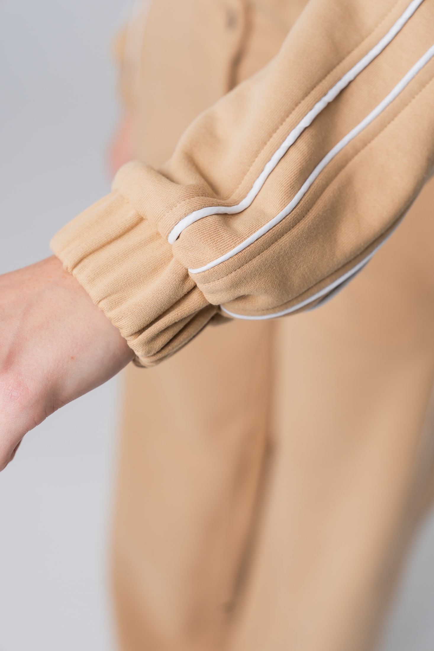 Women’s beige 100% cotton sweatshirt jacket with white contrast stripes and ribbed cuffs