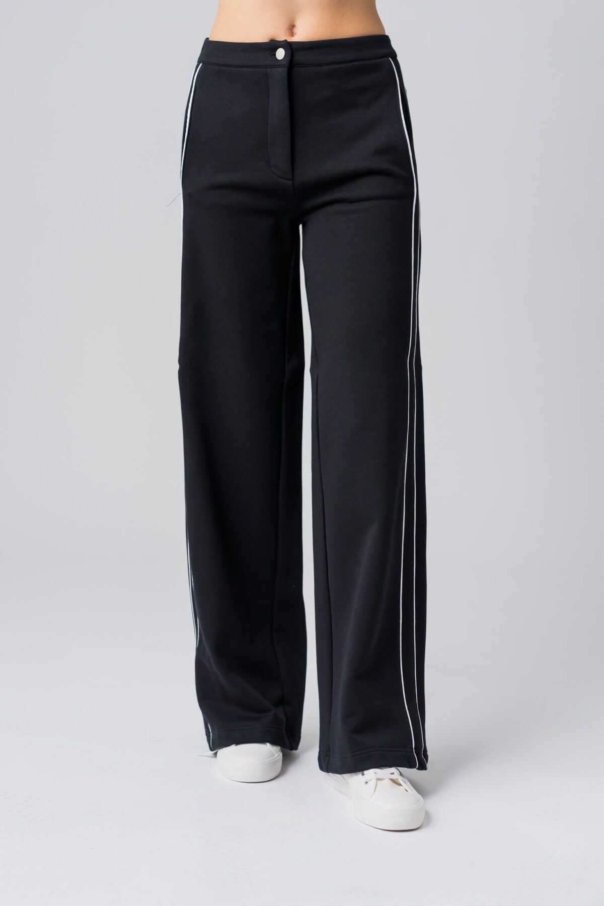 Women’s black 100% cotton high-waist sweatpants with white contrast piping and a buttoned waist