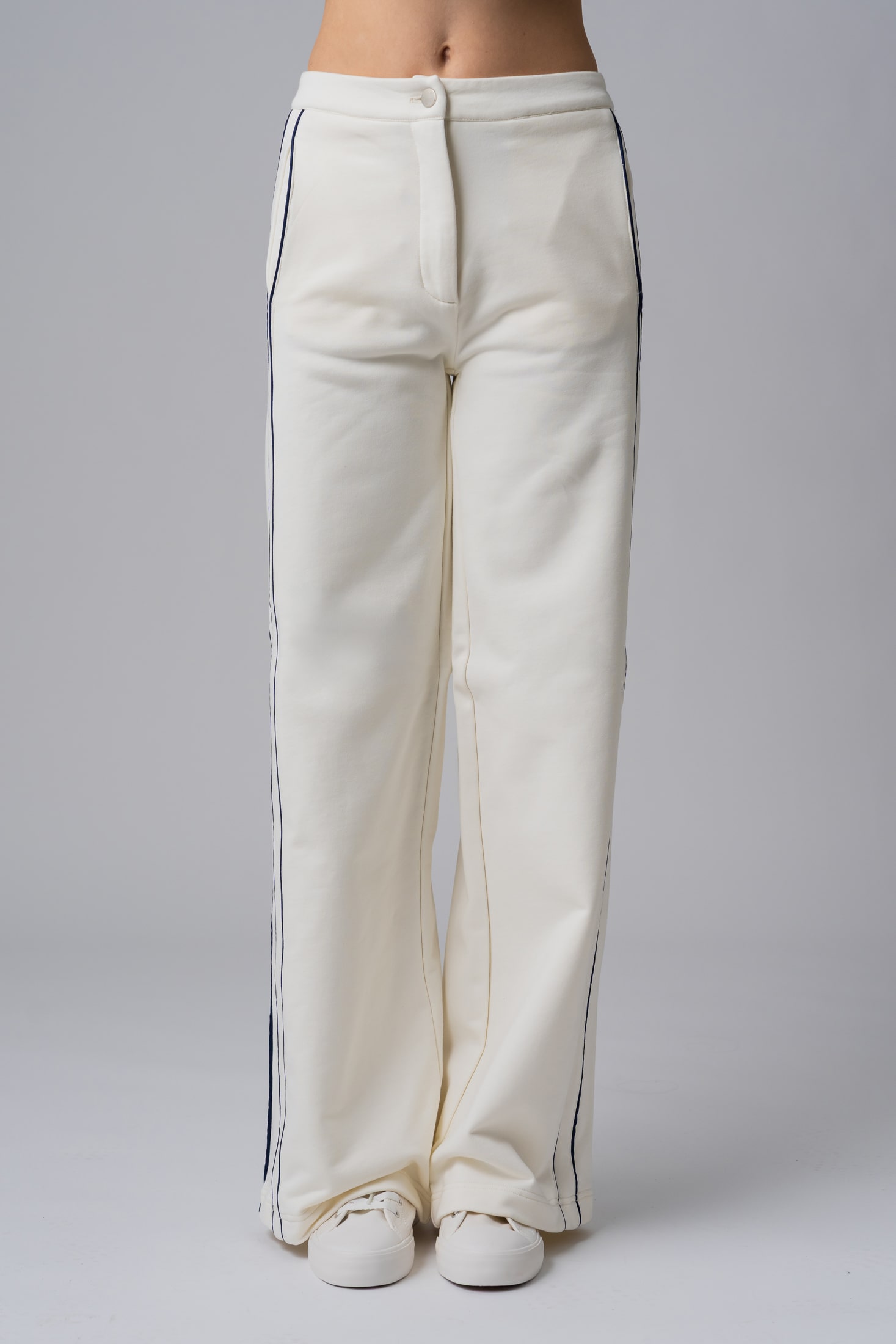 Women’s white 100% cotton high-waist sweatpants with black contrast piping and a buttoned waist